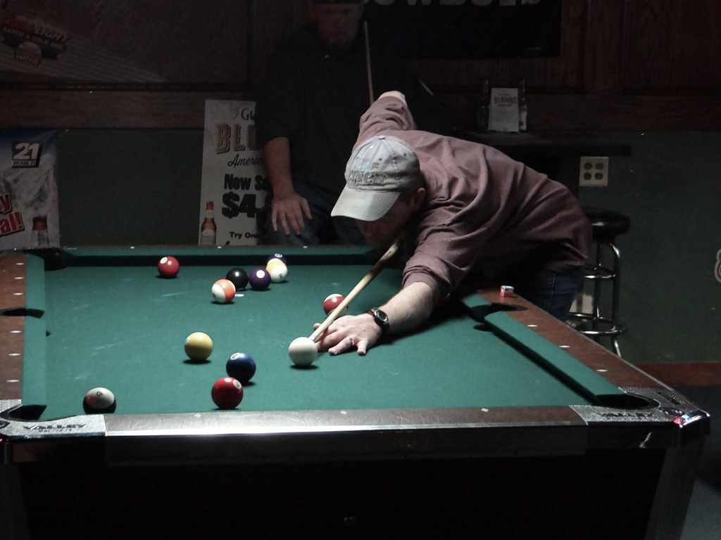 APA player on a bar pool table